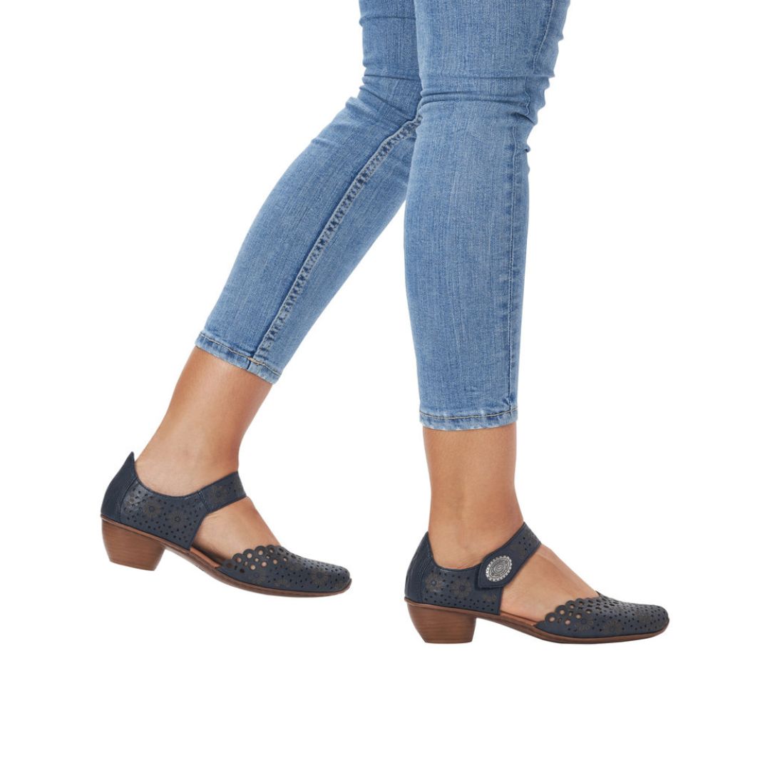 Navy leather Mary-Jane heels worn with jeans.