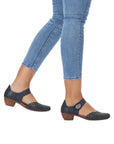 Navy leather Mary-Jane heels worn with jeans.