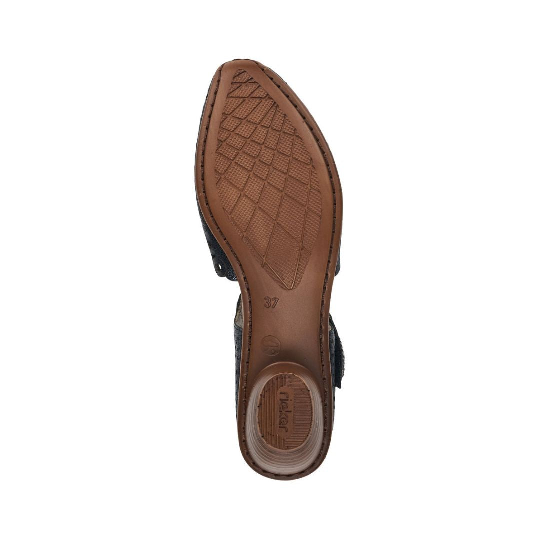 Brown light treaded outsole of navy heeled Mary-Jane with Rieker logo on heel.