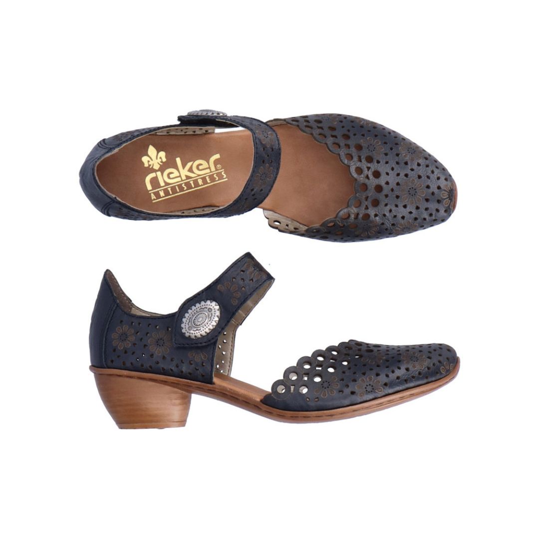Pair of navy heeled open sided Mary-Jane with Velcro ankle strap, floral pattern, decorative perforations and a low stacked heel.