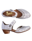 Pair of Silver heeled open sided Mary-Janes with Velcro ankle strap, floral pattern, decorative perforations and a low stacked heel.
