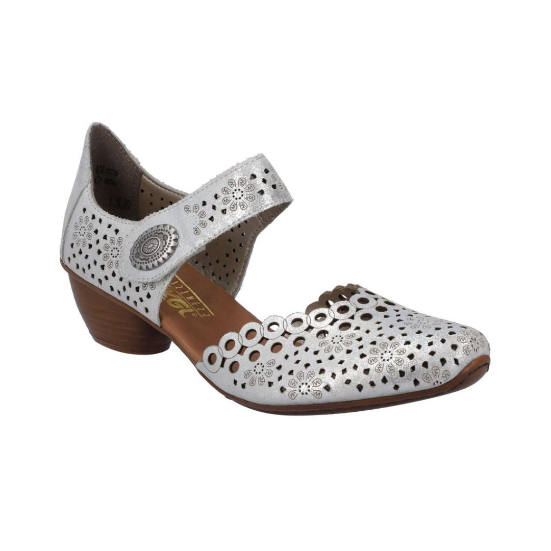 Silver heeled open sided Mary-Jane with Velcro ankle strap, floral pattern, decorative perforations and a low stacked heel.