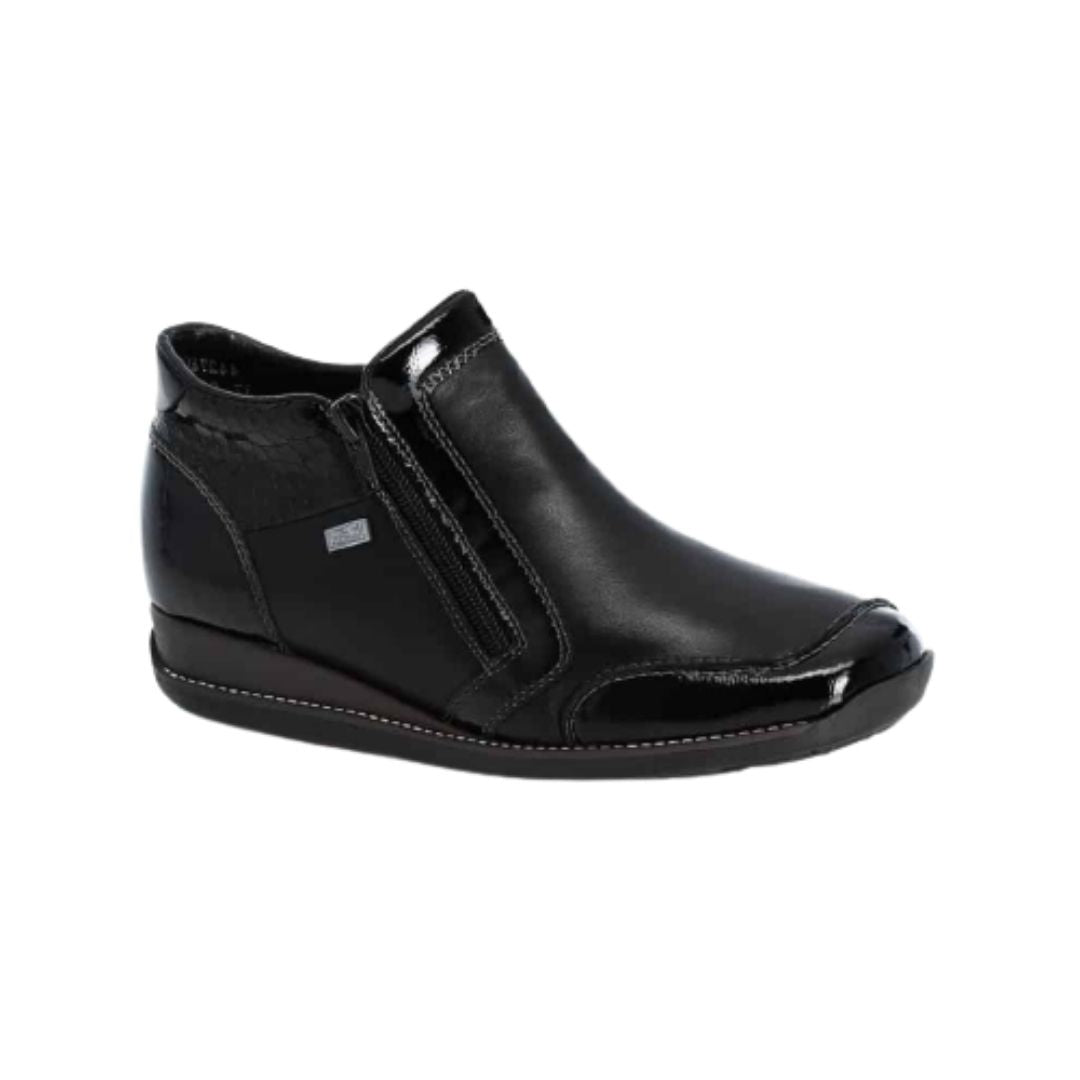 Black leather ankle boots with side zipper, patent accents, detail stitching and wedge heel.