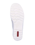 Outsole of Women's Rieker 48951 Velcro Shoe in beige, featuring a textured white sole for enhanced grip and flexibility.