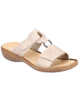 Beige slide sandal with two Velcro straps, textured details and medallion accent, tan Rieker logo'd footbed and brown outsole.