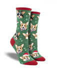 Women's Socksmith Pawlidays Socks in green with red trim, decorated with cheerful holiday Corgi dog faces. Perfect cotton crew socks for Christmas.