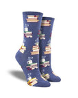 Blue socks with stacks of books and coffee mug at top