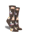 Brown socks with stacks of books and coffee mug at top
