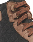 Close-up of Women's Sorel Evie II NW Lace Wedge Bootie showing brown laces, metal eyelets, and waterproof leather stitching detail.