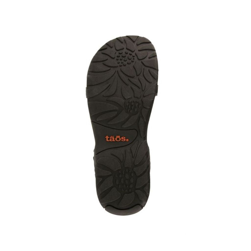 Outsole of Women's Taos Trophy 2 Backstrap Sandal featuring floral tread pattern for enhanced grip and stability.