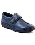 Navy slip on shoe with Velcro cross strap with metal detail and detailing stitching