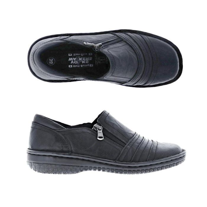Pair of Black slip-on women's shoes with a side zipper,  textured sole, and decorative folded leather across the front.