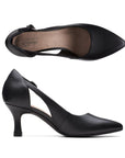 Top and side view of black leather pointed to pump with low kitten heel and adjustable side strap. Clarks logo is on heel of insole.