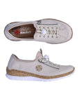 Pair of Slip-on Sneaker in cream with bungee laces, decorative side zipper, tan Rieker logo'd footbed, faux cork midsole and white outsole.
