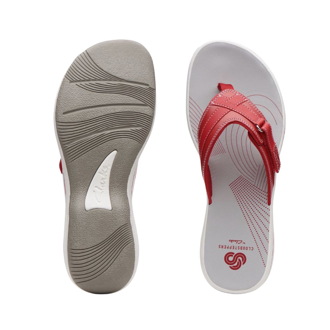Top and bottom view of Breeze Sea thong sandal in red. Clarks branding visible on footbed and outsole.