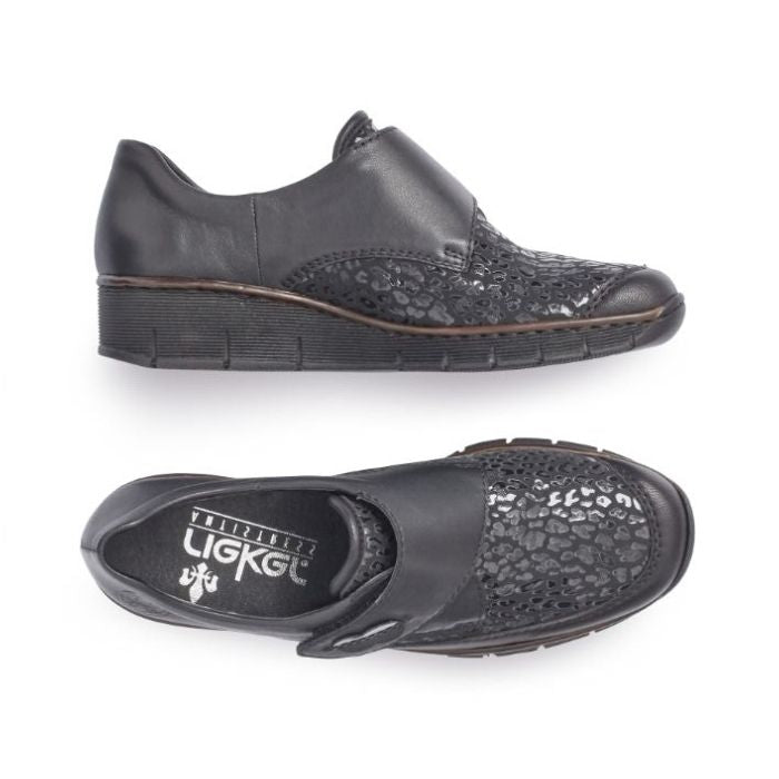 Top and side view of the black Slip-on casual 537C0-00 by Rieker has a cross foot velcro closure, sparkle detailing at the foot upper, slight wedge heel and brown trim line