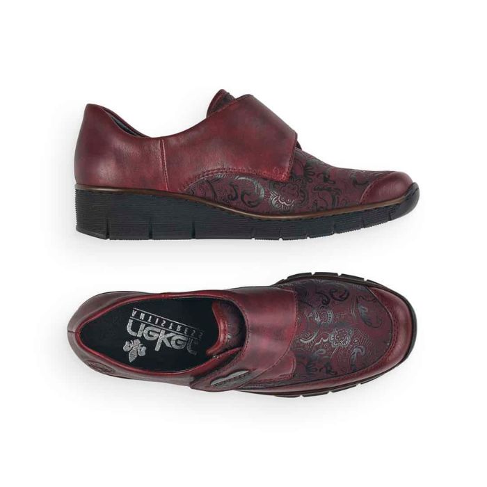 Top and side view of red Rieker 537C0 slip-on shoes for women, featuring floral pattern and flexible sole for casual wear.
