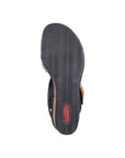 Black light treaded outsole of wedge sandal with red Rieker logo stamped on heel.