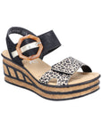 Black and leopard print straps on a wedge sandal with a faux buckle on top Velcro strap and a faux cork wedge midsole with black accent lines.