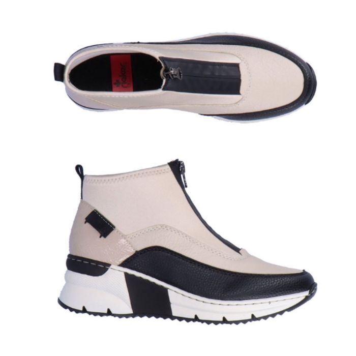 A pair of white Rieker top zipper sneaker with black accents and black and white wedge outsole.