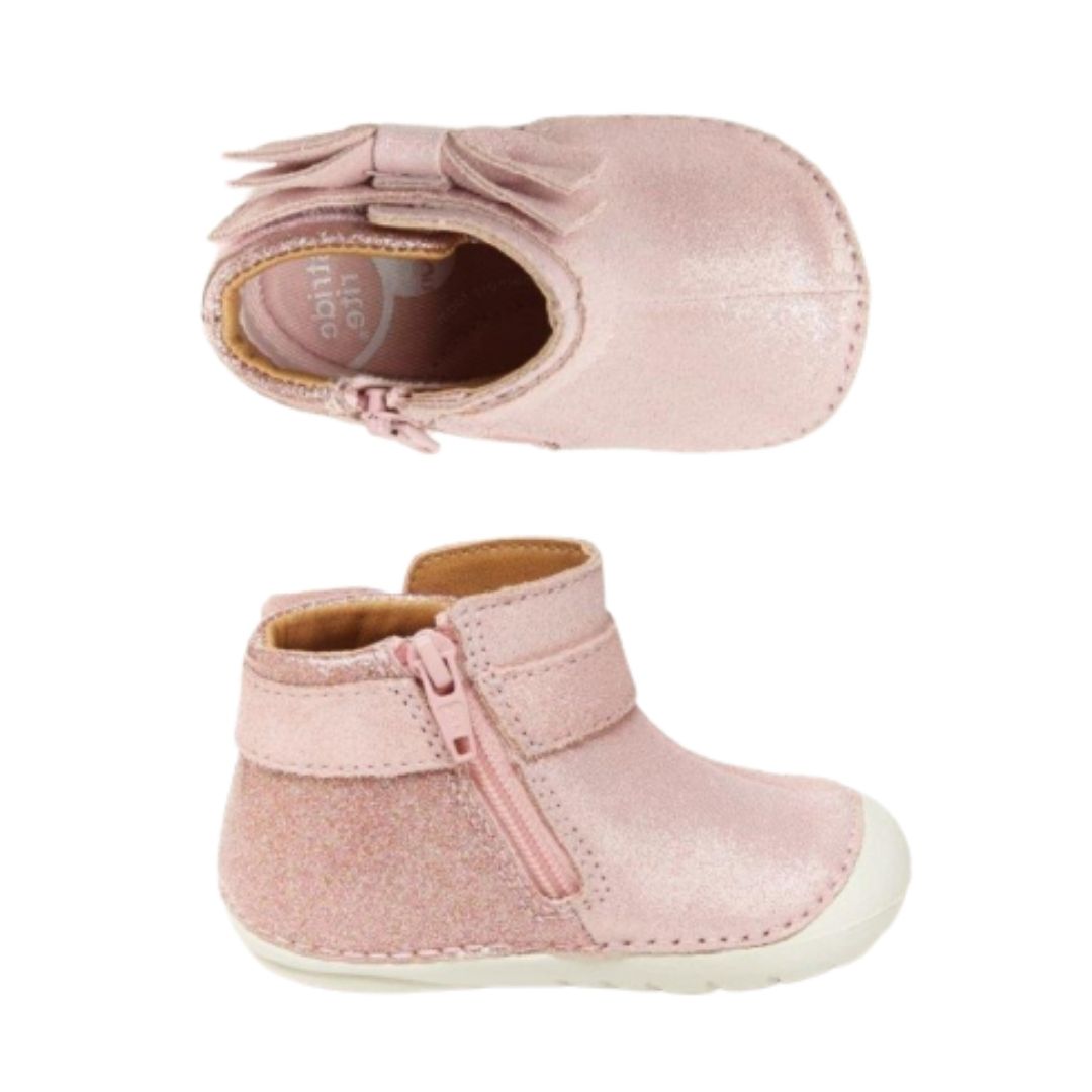 Top and side view of sparkly pink leather ankle bootie with side bow, inside zipper and white outsole