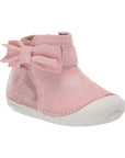 Sparkly pink leather ankle bootie with side bow and white outsole