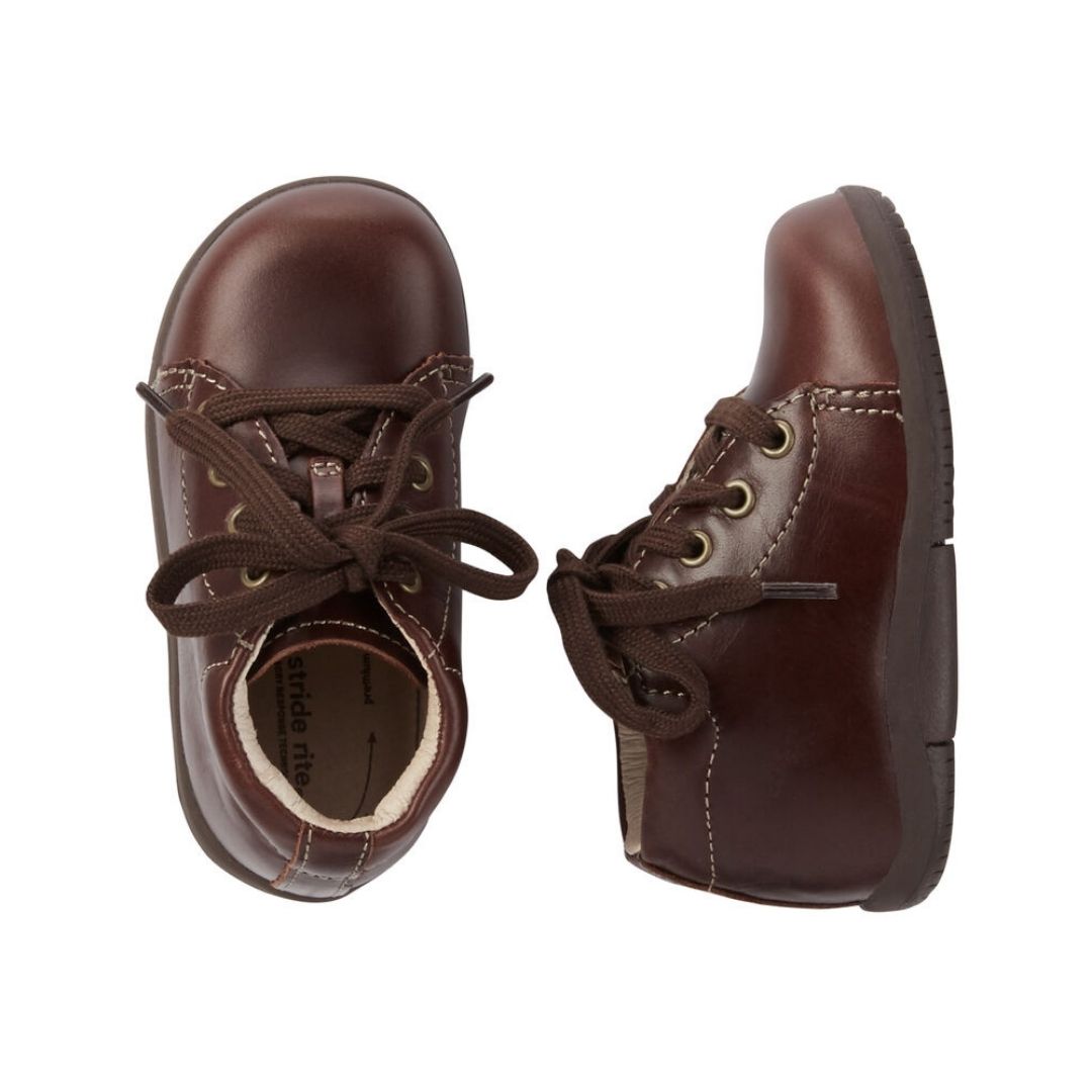 Top and side view of brown Kids Stride Rite Elliot Bootie showing soft leather upper and supportive structure for toddler foot development.