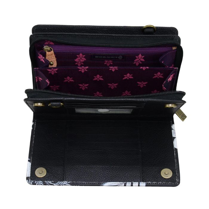Inside view of Anuschka crossbody bag with card slots and purple lining.