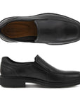 A pair of Ecco black leather slip on dress shoes with apron stitching and a square toe. Outsole is black.