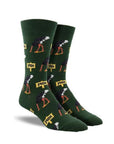 Green socks with patterned with ostrichs burying heads in ground and 'NOPE' text on yellow signs.