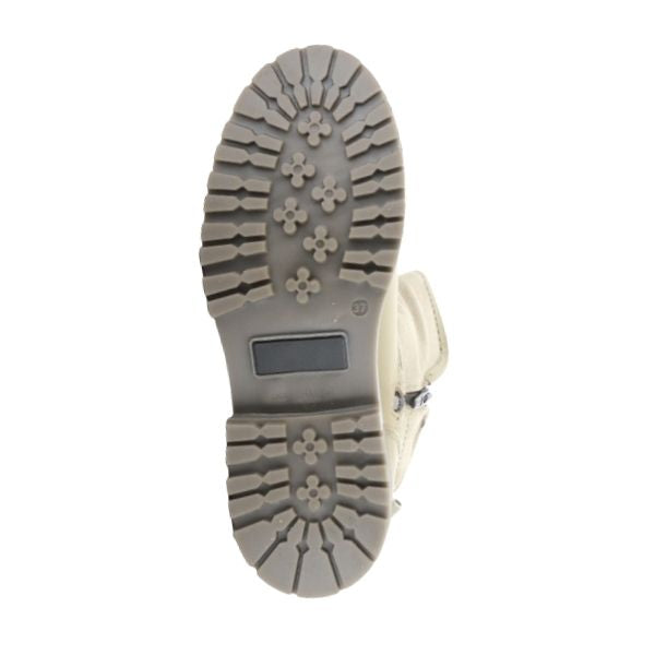 Bottom view of beige Anova Boot outsole with deep lugs for enhanced grip on snowy surfaces.