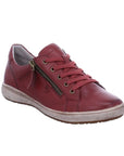 Caren 12 Sneaker in Bordo. Red leather upper with red laces, a side zipper, and bronze hardware. Midsole is grey, outsole is brown.
