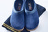Cozy blue indoor slippers on folded striped socks for home comfort