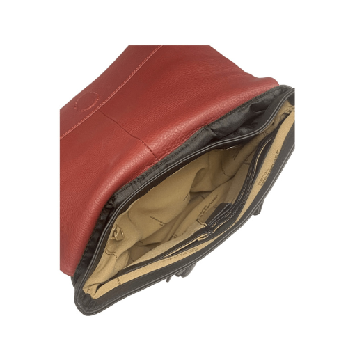 Interior of black leather backpack with light brown fabric lining, organizational pockets, red interior flap and detail stitching.