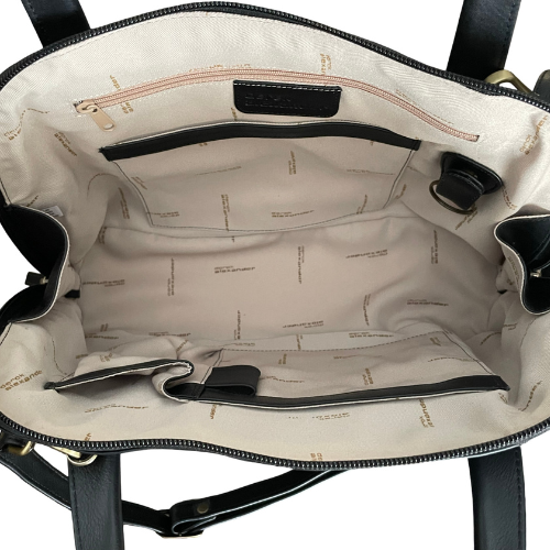 Open handbag showing interior with organization pockets, light fabric and a deep main compartment.