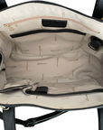 Open handbag showing interior with organization pockets, light fabric and a deep main compartment.