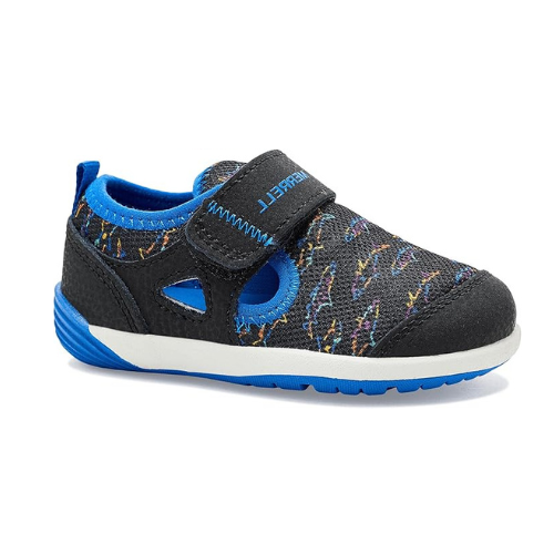 Black children's shoe with colorful shark outlines, blue lining and white and blue outsole.