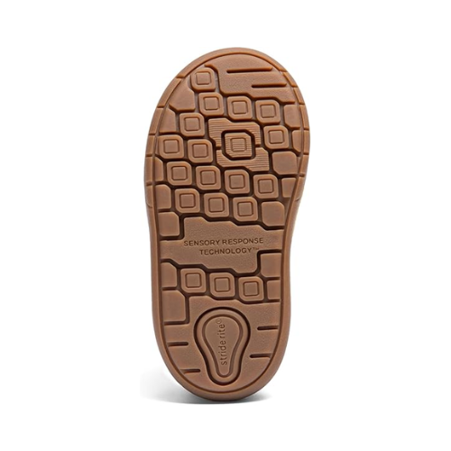 Brown outsole of children's shoe with sensory response stamped in middle and geometric designed tread.