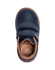 Top view of a navy blue children's shoe with two velcro straps, tan footbed and a brown outsole.