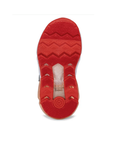 Bright orange outsole of kid's sneaker with zig-zag tread pattern. 