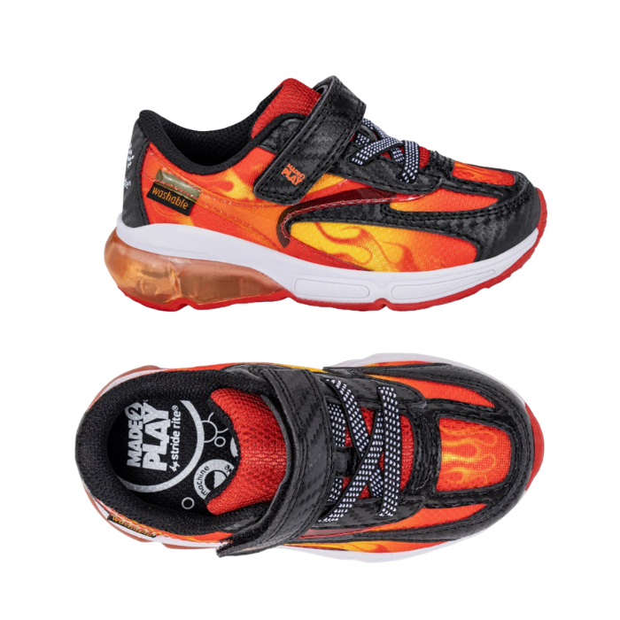 Pair of toddler's athletic sneakers featuring a red, orange, and yellow flame pattern on a black base, with a hook-and-loop strap closure and a white midsole.