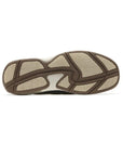 Brown and beige rubber outsole with wave pattern for grip.