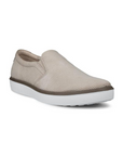 Beige slip-on shoe with light perforations and a white outsole.