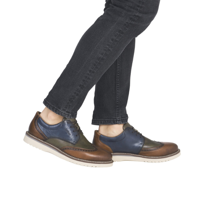 Brown and blue dress shoes worn with black jeans.