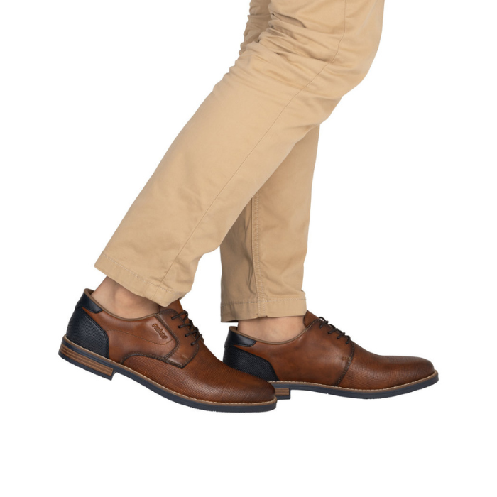 Brown leather dress shoes worn with beige pants.