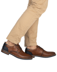 Brown leather dress shoes worn with beige pants.