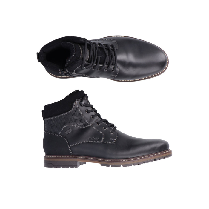 Pair of Black leather ankle boots with black laces, accent stitching and brown midsole above black treaded outsole.