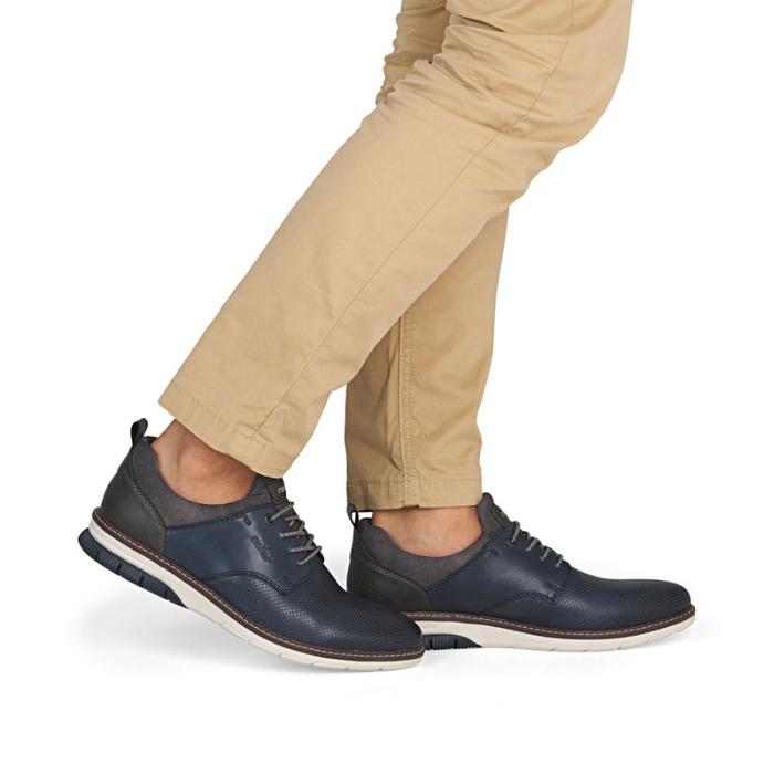 Navy blue shoes worn with beige pants.