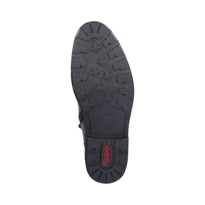 Black rubber outsole of men's boot with red Rieker logo on heel.