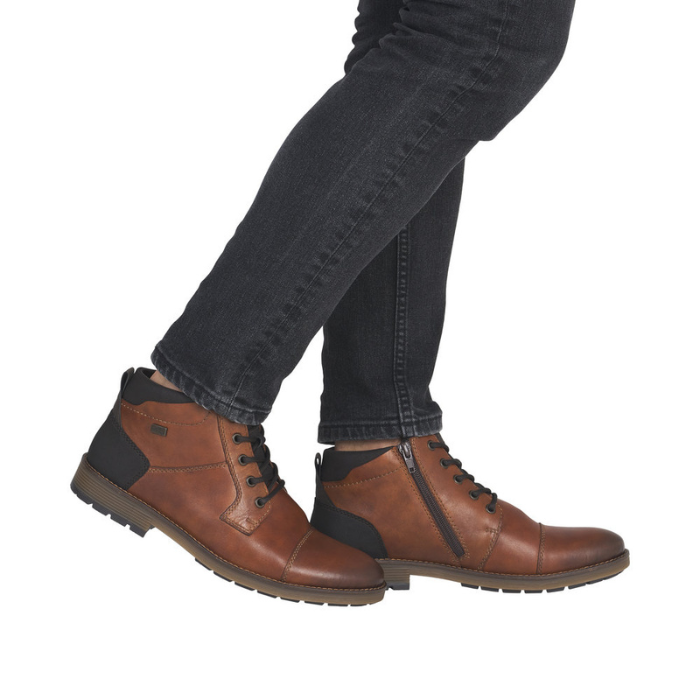 Brown dress boots with black jeans.